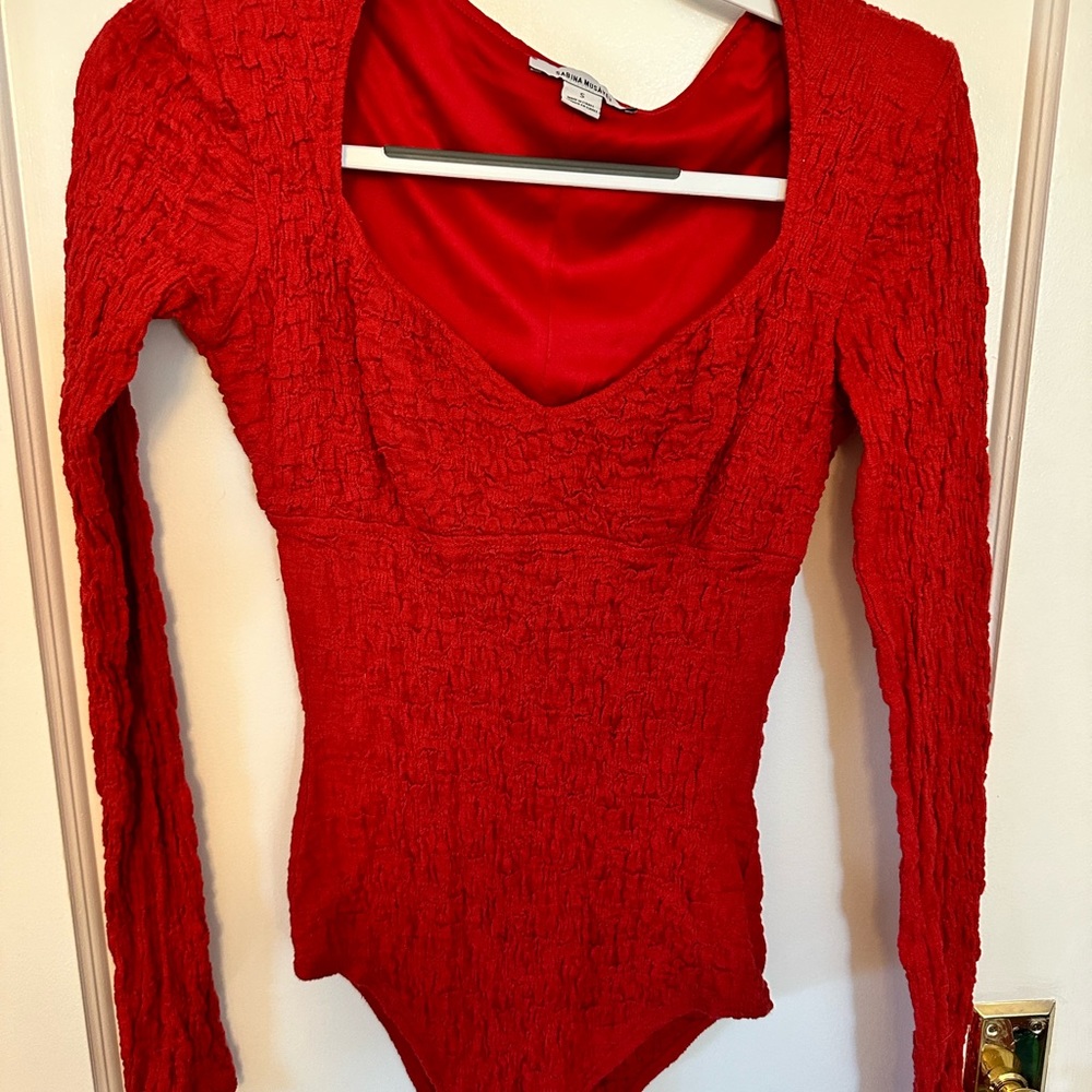 Red bodysuit by Sabina Musayev
